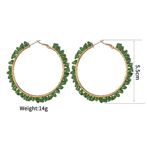 Detail of 5.5cm gold wire wrapped green crystal hoop earrings showing size and weight