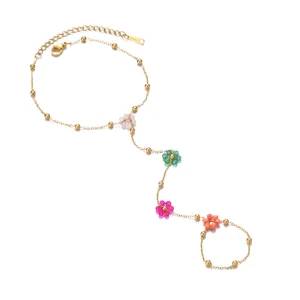 Gold-plated stainless steel slave bracelet with colorful beaded flower charms on white background