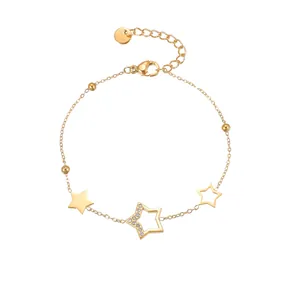 Detailed macro view of 18K gold plated steel chain bracelet with star charms and crystals