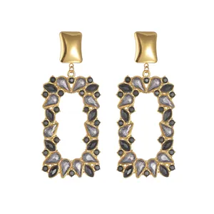 Gold-plated geometric rectangle drop earrings with grey and black gemstones on white back