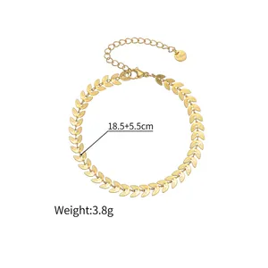Macro detail of 18k gold wheat leaf bracelet showing S.steel engraving and size labels