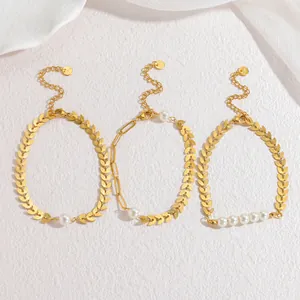 Close-up of three 18k gold-plated wheat-ear bracelets with elegant white pearls