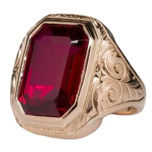 Vintage men's gold-plated ring featuring a large red zircon gemstone with baroque relief