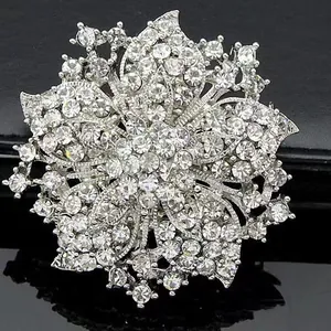 Elegant silver bauhinia floral brooch encrusted with sparkling rhinestones on black background