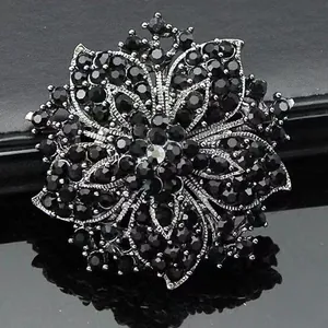 Elegant floral wreath brooch with black rhinestones and multi-layered silver petals