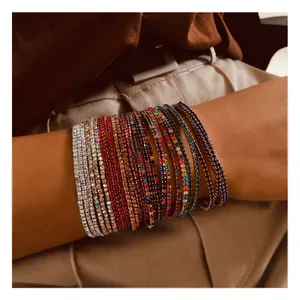 Sparkling multi-color crystal tennis bracelets set worn on a female wrist for layering