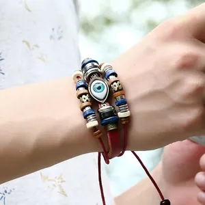 Braided leather evil eye bracelet with red rope and wooden beads for men and women