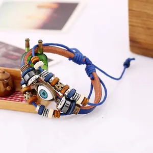 Handmade multilayer leather bracelet with evil eye charm and wooden beads in boho style