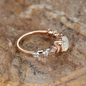 Elegant rose gold opal ring with side diamonds on natural rock for a vintage aesthetic