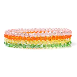 Detail of stacked colorful faceted crystal beaded bracelets in pink, orange and yellow