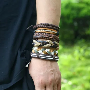Close-up of vintage multi-layer woven leather bracelet set worn on a male wrist