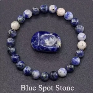 Natural blue spot stone beaded bracelet with matching raw stone on grey background