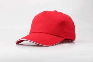 Detail of red cotton baseball cap showing twill fabric texture and white sandwich peak design