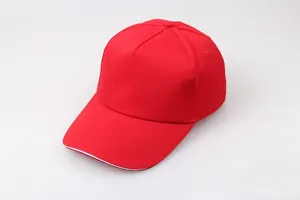 Close-up of red cotton baseball cap with white sandwich brim detail and five-panel design