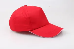 Detail view of red cotton baseball cap with five-panel design and white sandwich brim