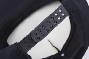 Close-up of the adjustable black plastic snapback closure on a foam trucker hat
