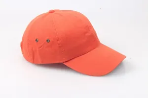 Detail view of the orange safety bump cap showing metal ventilation eyelets and stitching