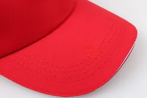 Macro shot of red cotton baseball cap brim with parallel stitching and white layer detail