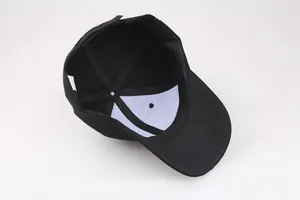 Detail showing internal structure of a six-panel black cotton baseball cap with reinforced seams
