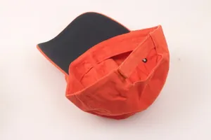 Orange safety baseball helmet with reinforced cotton fabric and ventilated crown design
