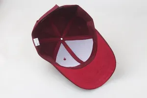 Detail view of burgundy baseball cap interior showing sewing seams and white care label