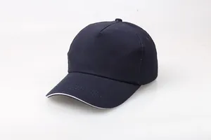 Detail view of navy blue cotton baseball cap with subtle white sandwich brim piping