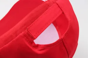 Detailed macro view of the adjustable cotton strap and red stitching on the baseball cap
