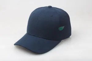 Detail view of the navy blue cotton twill texture and six-panel stitching on the baseball cap