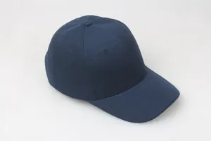 Detail of navy blue cotton twill baseball cap with six-panel structure and embroidered eyelets