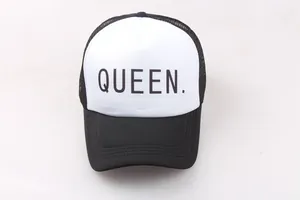 Detailed view of Queen lettering on a black and white trucker hat with mesh back