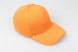 Detail of bright orange baseball cap showing reinforced stitching and breathable eyelets