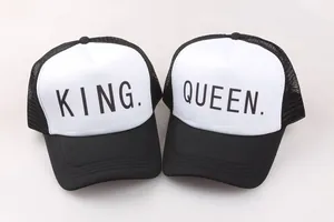 Detail of King and Queen matching trucker hats with breathable black mesh and white front