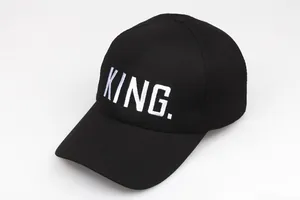 Close-up of white King embroidery on black cotton baseball cap with twill texture