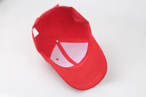 Detailed interior of red cotton baseball cap showing six-panel stitch and care label