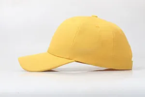 Detailed side view of ginger yellow twill cotton baseball cap with curved brim and 6-panels