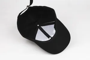 Detailed close-up of the adjustable metal buckle and stitching on the black cotton baseball cap