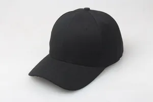 Macro shot of pure black cotton baseball cap showing 6-panel stitching and curved brim detail