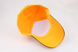 Detail view showing internal stitching and black trim of a bright yellow cotton baseball cap