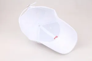 Internal details of white baseball cap showing six-panel stitching and metal buckle
