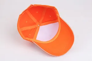 Detail view of cotton baseball cap interior showing six-panel stitching and orange fabric