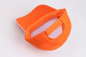 Detail of orange cotton baseball cap showing white inner lining and adjustable velcro strap
