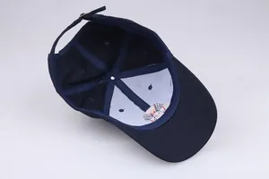 Inside view of navy blue cotton baseball cap showing internal seams and metal buckle