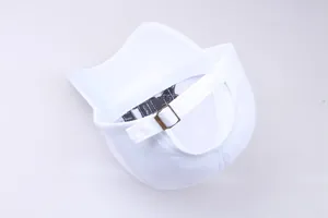 Rear view of white canvas baseball cap with vintage metal buckle and precise stitching