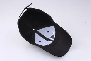 Detail view of the black cotton baseball cap interior featuring a metal buckle and stitching
