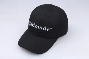 Black cotton baseball cap with white $elfmade embroidery and a curved brim for unisex
