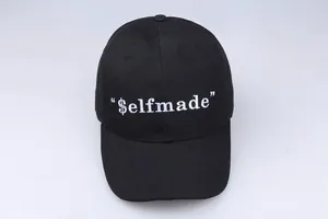 Classic black street style baseball cap with white $elfmade embroidery and curved brim