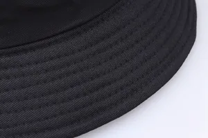 Close-up of black bucket hat showing high-density twill cotton and multi-row stitching