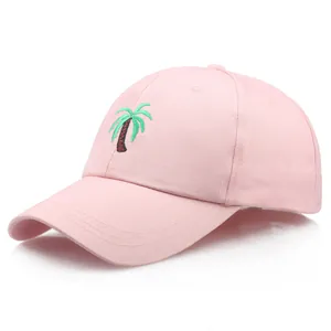 Pink cotton baseball cap with green palm tree embroidery and curved brim in side view