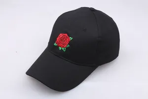Detailed close-up of a black cotton baseball cap featuring a red rose embroidery pattern