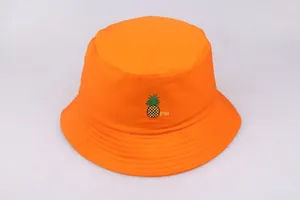 Detalle del sombrero de pescador en algodón naranja con bordado de piña y texto Pin